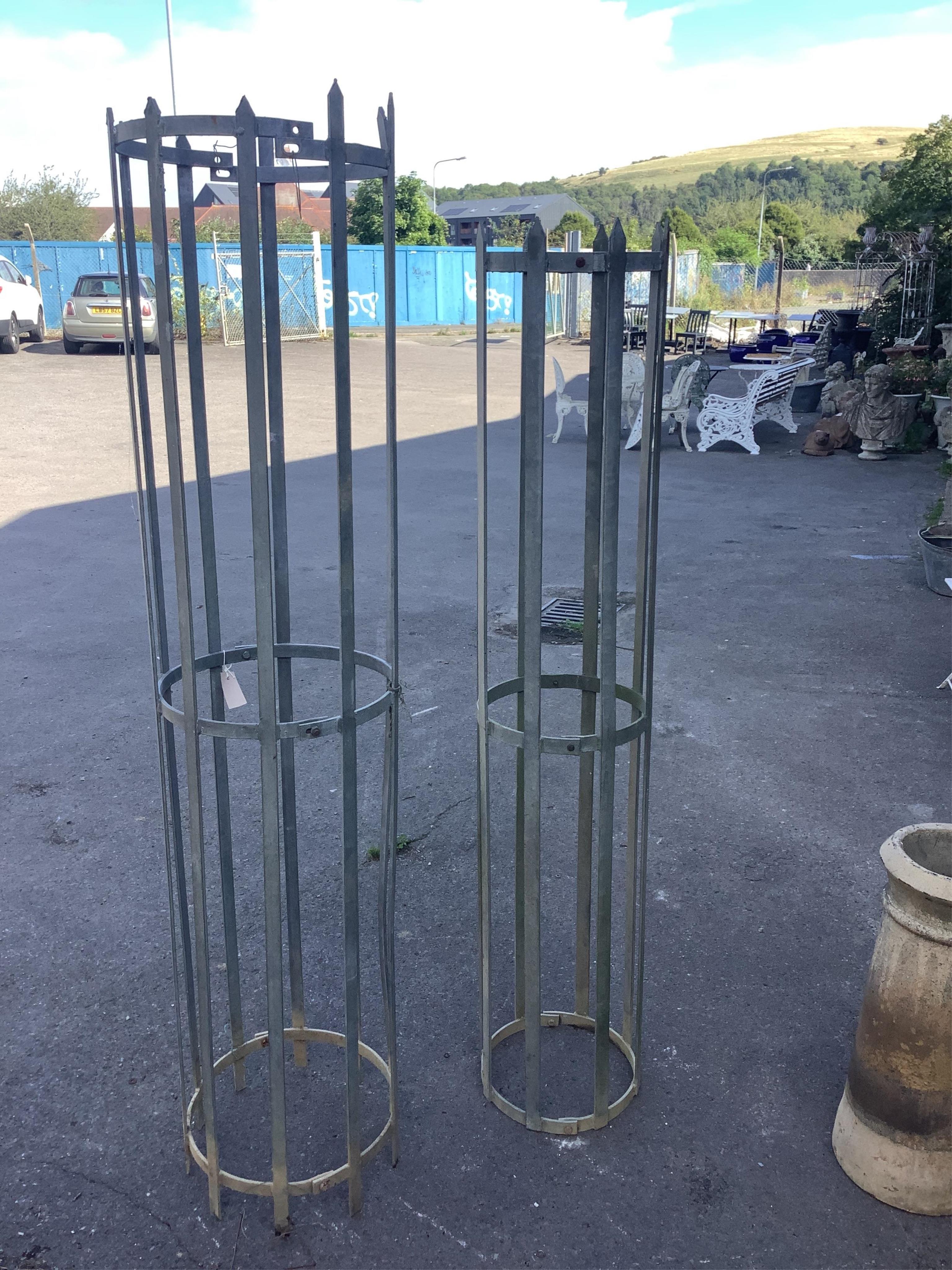 Two wrought iron tree guards, largest height 180cm. Condition - fair